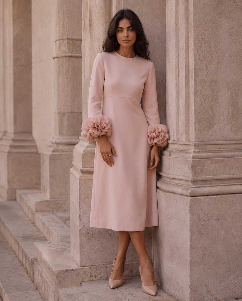 Model in a blush midi dress with ruffled cuffs — ITALICA Boutique Sarasota